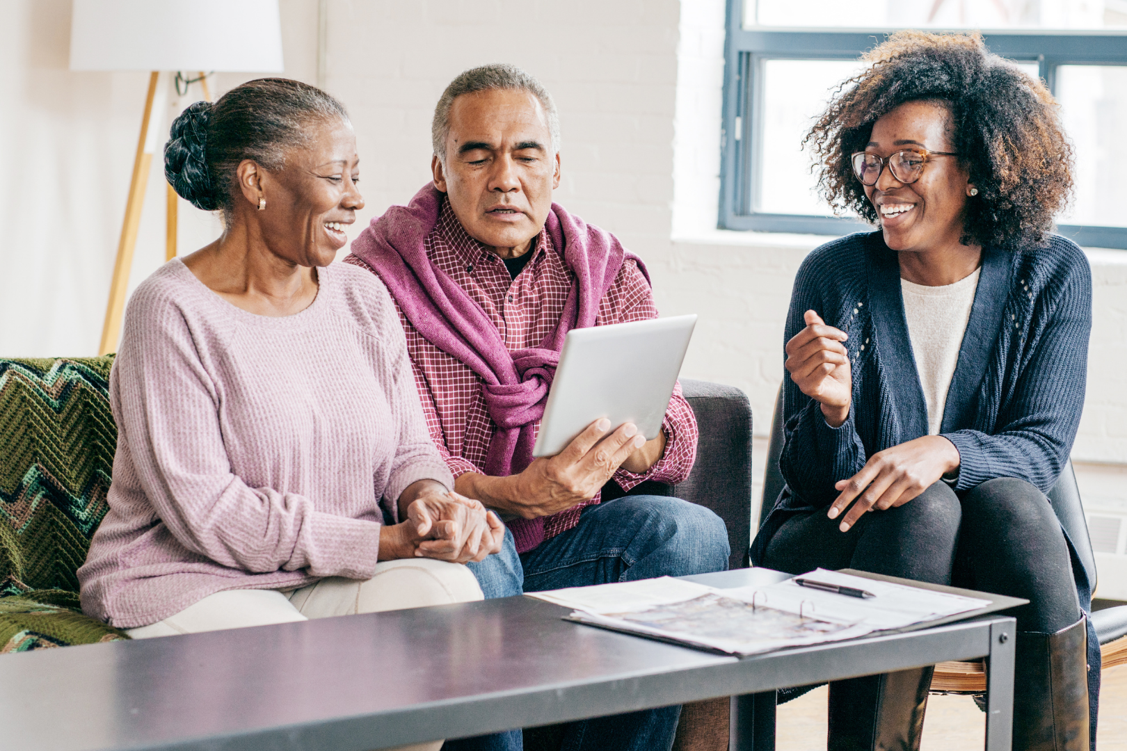 Wills and probate planning – elderly couple reviewing documents with a legal adviser, representing inheritance and estate services from Martin Shepherd Solicitors.