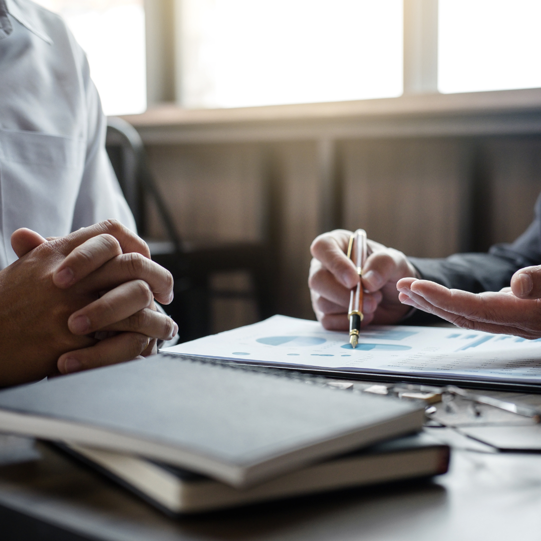 Solicitor discussing paperwork with a client representing compassionate legal guidance for executors, administrators and beneficiaries by Martin Shepherd Solicitors in Potters Bar, Hertford and North Finchley.