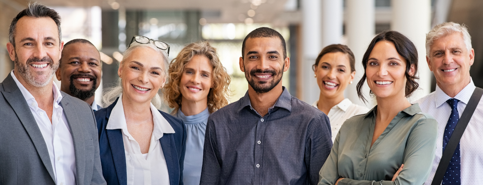 Diverse group of smiling professionals standing together representing the team at Martin Shepherd Solicitors in North London, Hertfordshire, Potters Bar, and surrounding areas.