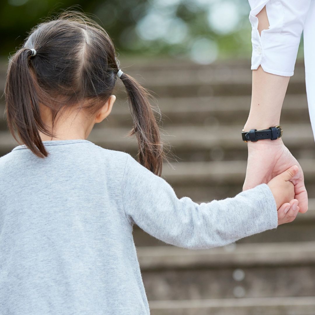 Child holding an adult’s hand, representing child arrangements support by Martin Shepherd Solicitors in North London and Hertfordshire.