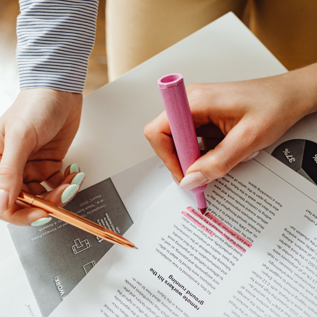 Hands highlighting text on a document representing the review and investigation of professional negligence issues by Martin Shepherd Solicitors in Potters Bar, Hertford and North Finchley.